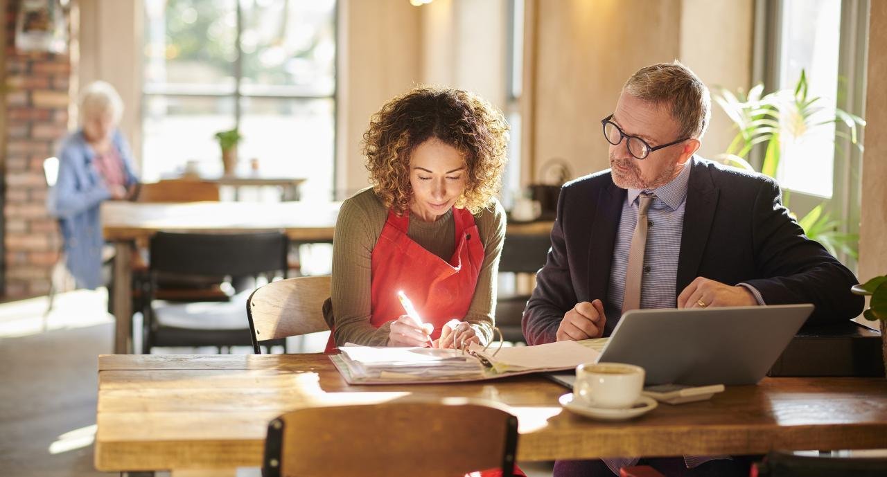 A CHL Guide sitting with a business owner, helping them get started